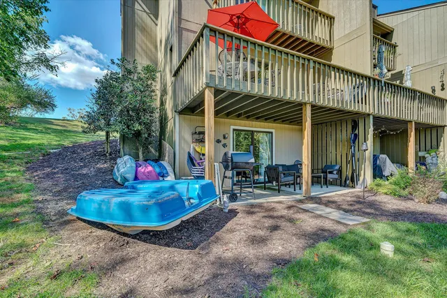 a view of a chair and table in backyard of the house