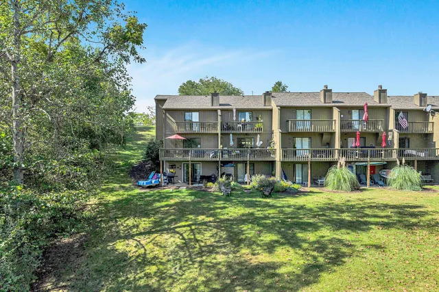 a view of a lake with a bench and trees