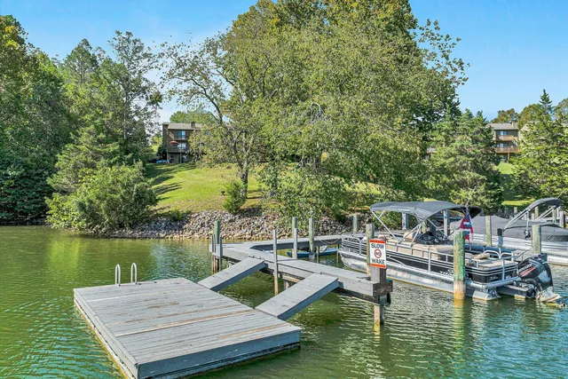 a view of a lake with couches chairs and table