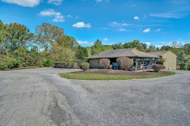 a view of a patio with table and chairs under an umbrella