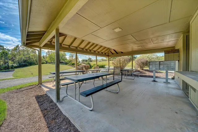 a building outdoor space with patio furniture and potted plants