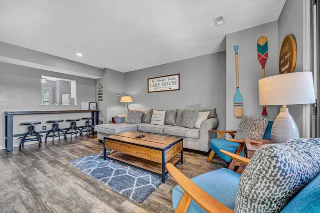 a living room with furniture rug and window