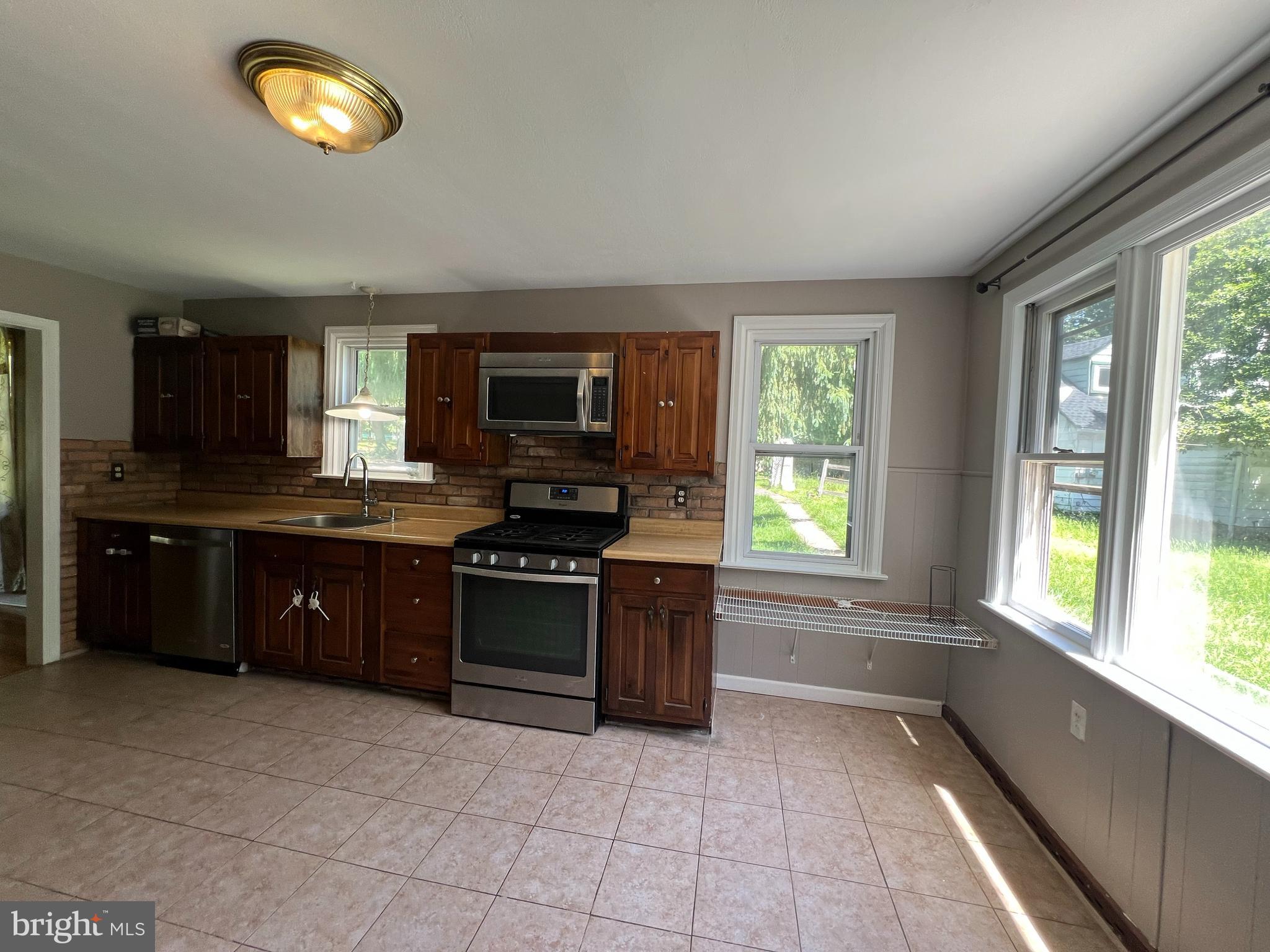 132 Conestoga Road Devon, PA 19333 - Photo 13 of 14 a large kitchen with a stove a sink and a microwave