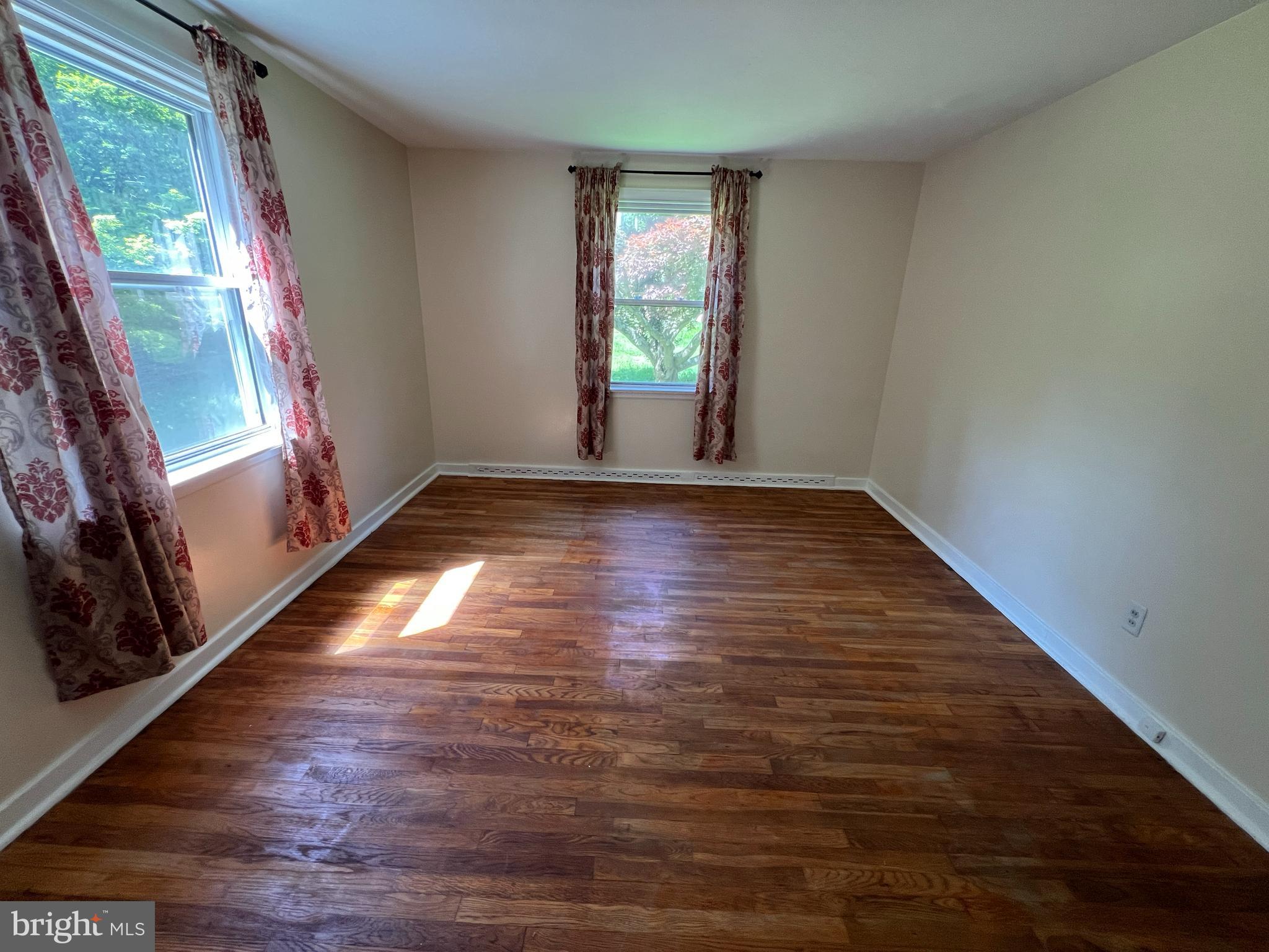 132 Conestoga Road Devon, PA 19333 - Photo 9 of 14 a view of an empty room with wooden floor and a window