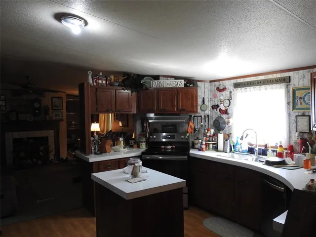 a kitchen with stainless steel appliances granite countertop a refrigerator and a stove