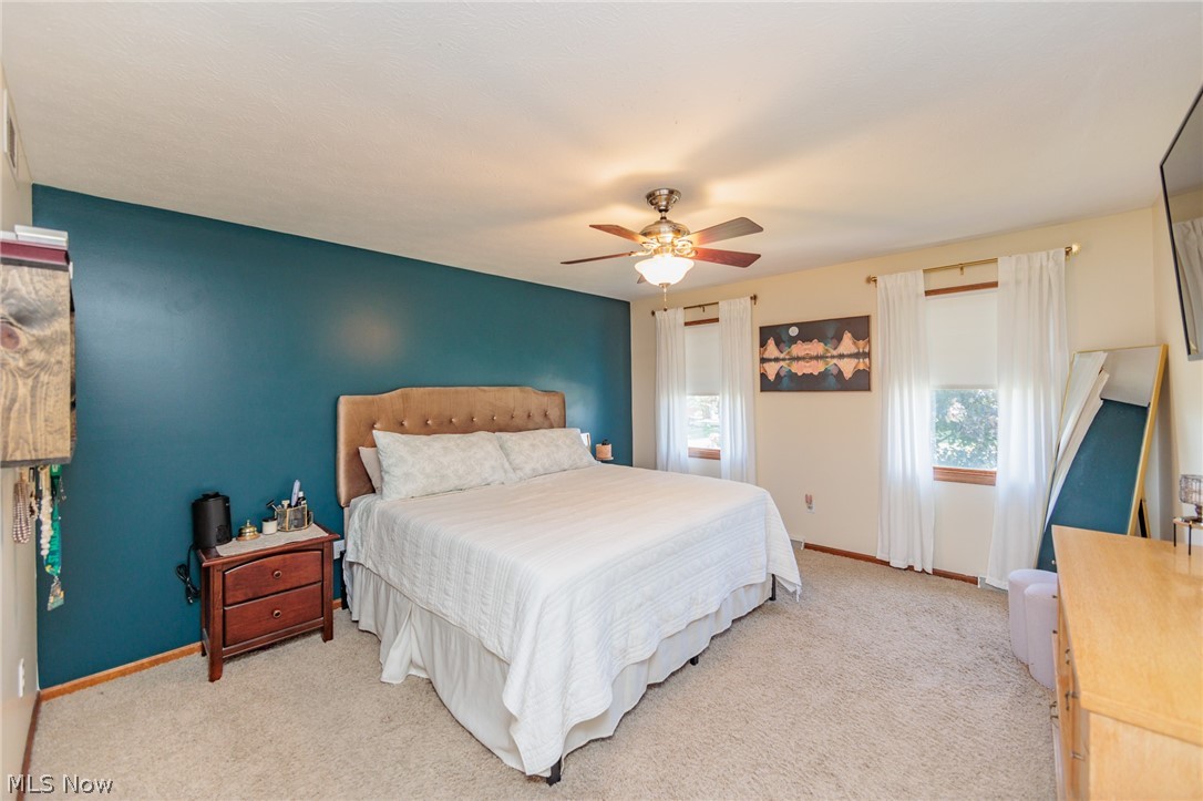 5630 Oak Point Road Lorain, OH 44053 - Photo 16 of 44 Primary Bedroom featuring light carpet and ceiling fan