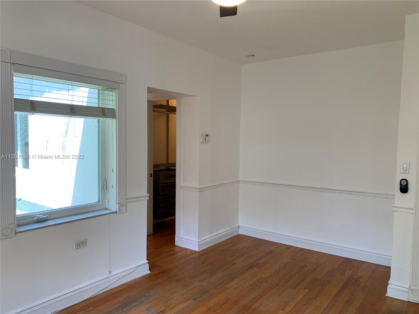 7236 School House Road Miami, FL 33143 - Photo 12 of 25 an empty room with wooden floor and windows