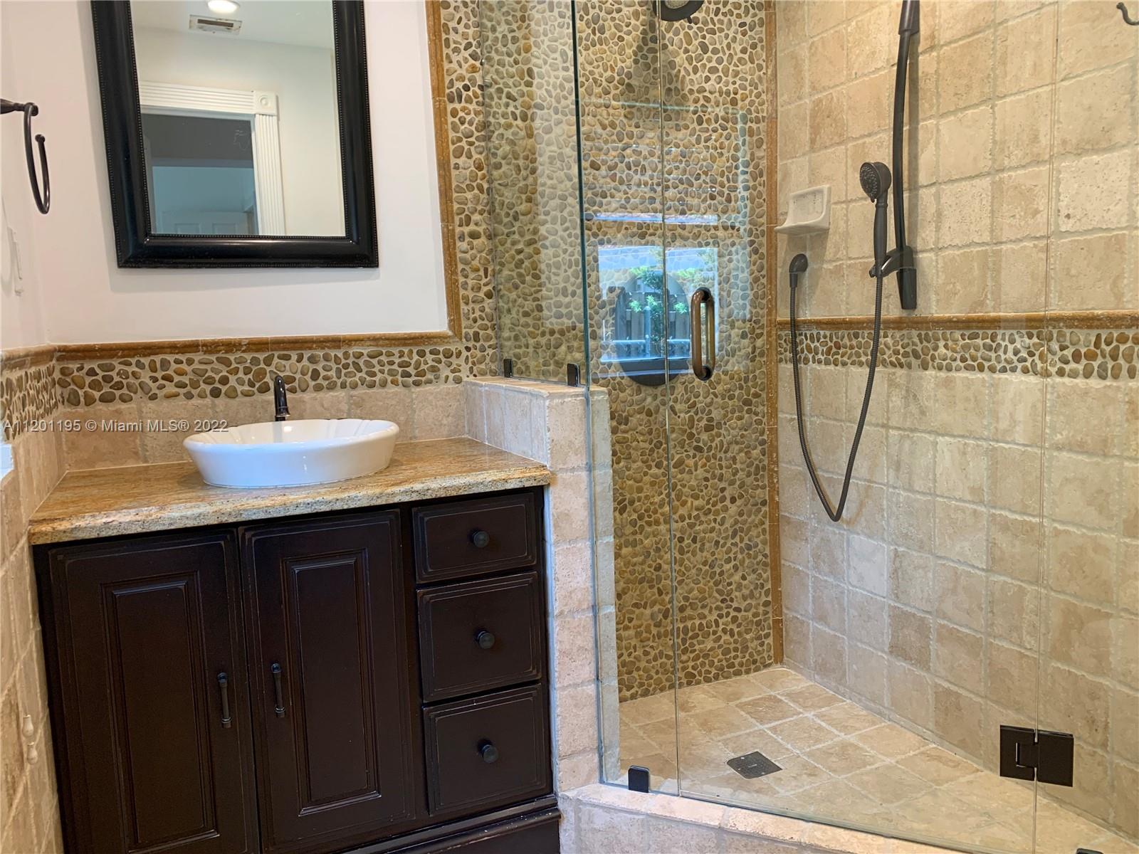 7236 School House Road Miami, FL 33143 - Photo 13 of 25 a bathroom with a sink and a mirror