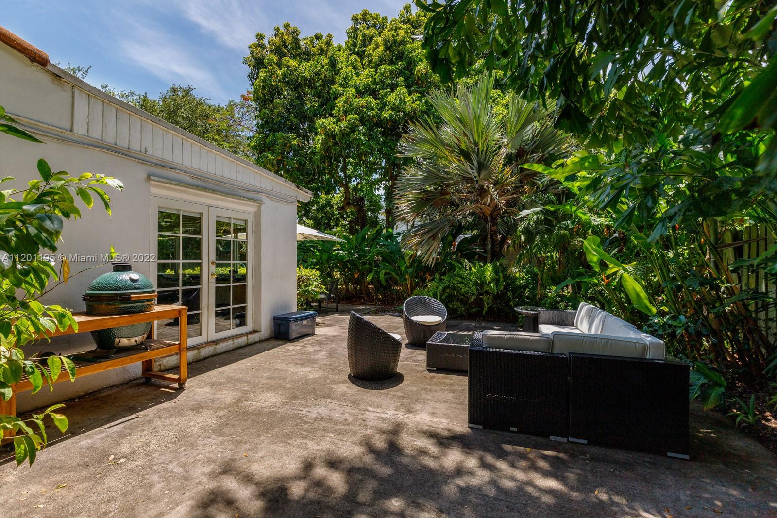 7236 School House Road Miami, FL 33143 - Photo 20 of 25 a backyard of a house with yard and outdoor seating