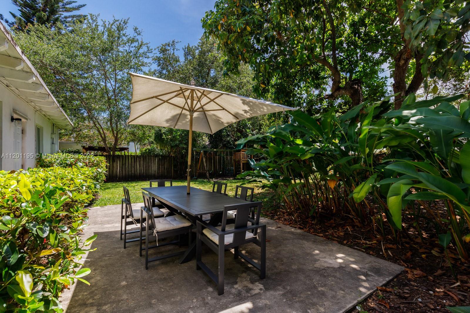 7236 School House Road Miami, FL 33143 - Photo 23 of 25 a view of backyard with seating space and trees