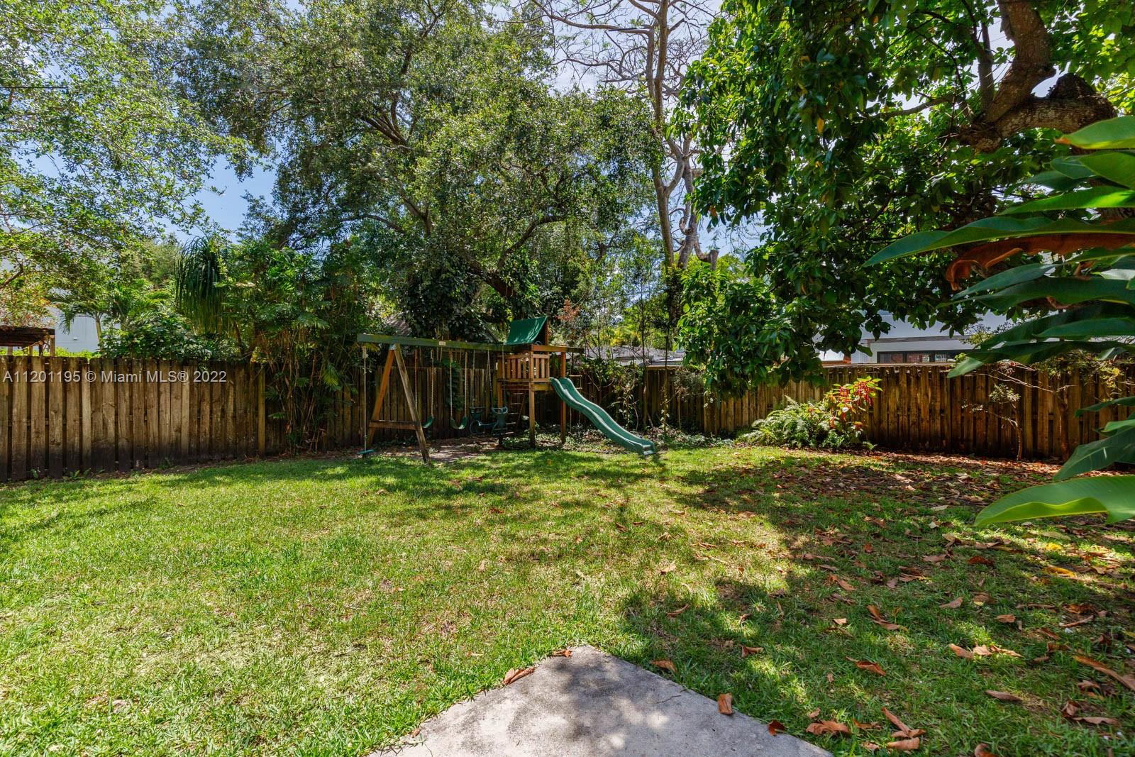 7236 School House Road Miami, FL 33143 - Photo 24 of 25 a backyard of a house with lots of plants and tree