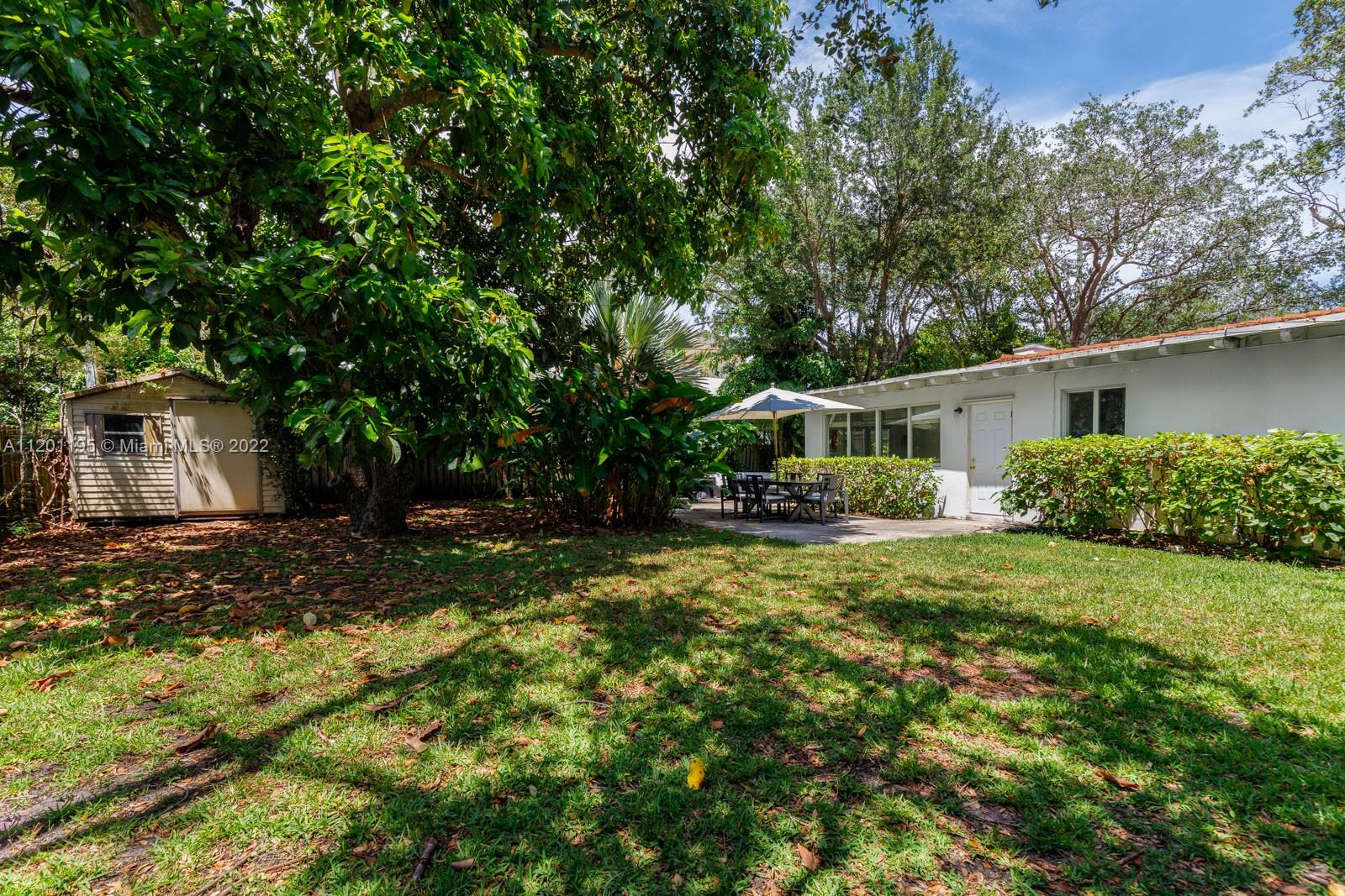 7236 School House Road Miami, FL 33143 - Photo 25 of 25 a view of a house with backyard and sitting area