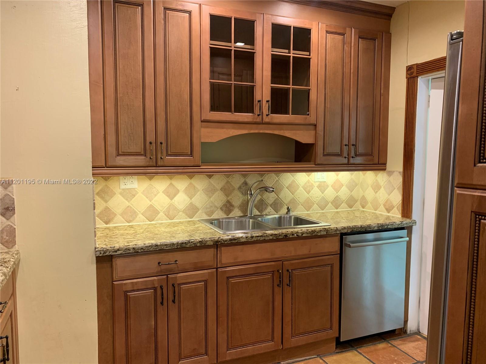 7236 School House Road Miami, FL 33143 - Photo 6 of 25 a kitchen with granite countertop cabinets and window