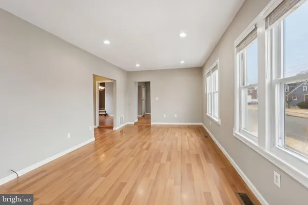 a kitchen with a sink wooden floor and stainless steel appliances