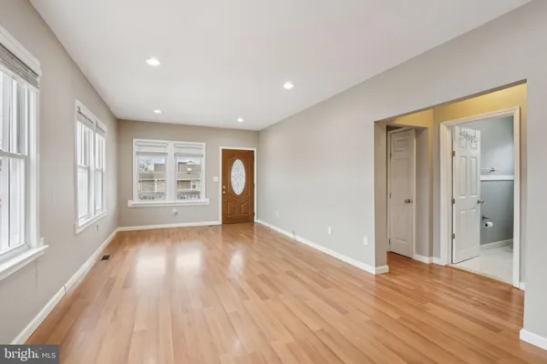 a view of wooden floor and a chandelier in a room