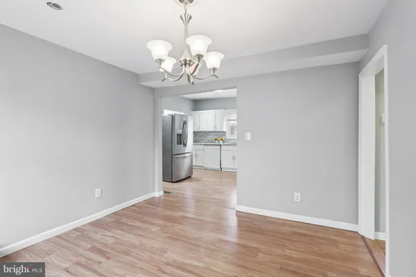 a view of a kitchen with a center island wooden floor and a window