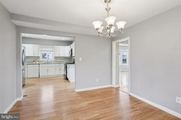 a view of a dining room with furniture and chandelier