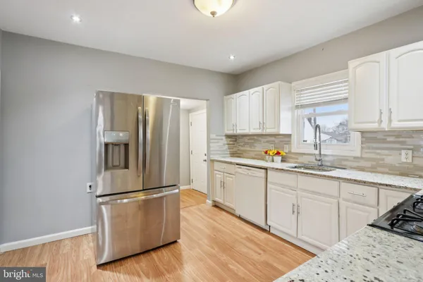 a bathroom with a toilet sink a mirror and vanity