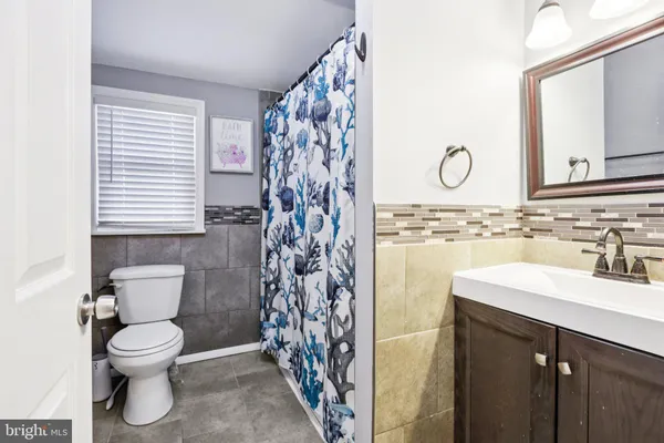 an empty room with fan and windows