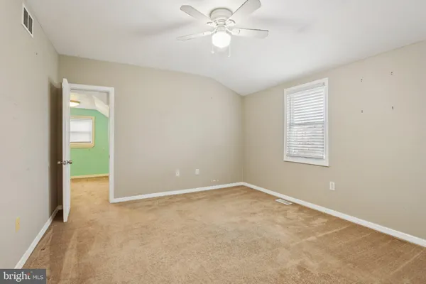 a bedroom with a bed couch and window