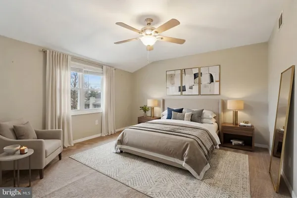 a view of a room that has a window and wooden floor