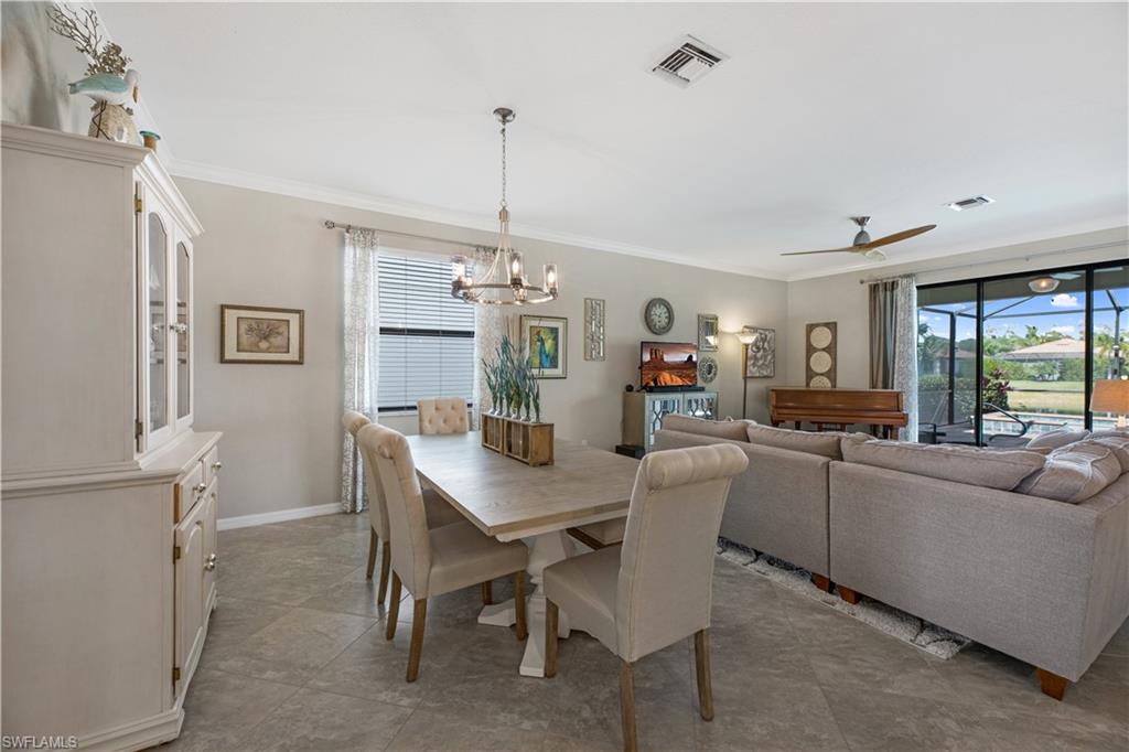 4375 Bismark Way Naples, FL 34119 - Photo 12 of 42 a view of a dining room with furniture window and wooden floor