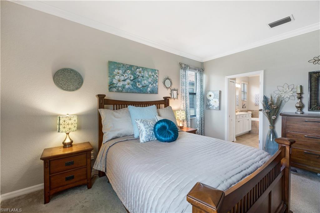 4375 Bismark Way Naples, FL 34119 - Photo 21 of 42 a bedroom with a bed and wooden floor