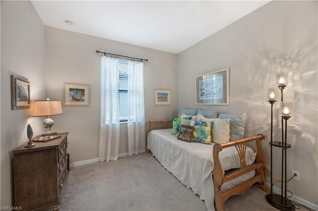 4375 Bismark Way Naples, FL 34119 - Photo 24 of 42 a living room with furniture and a lamp