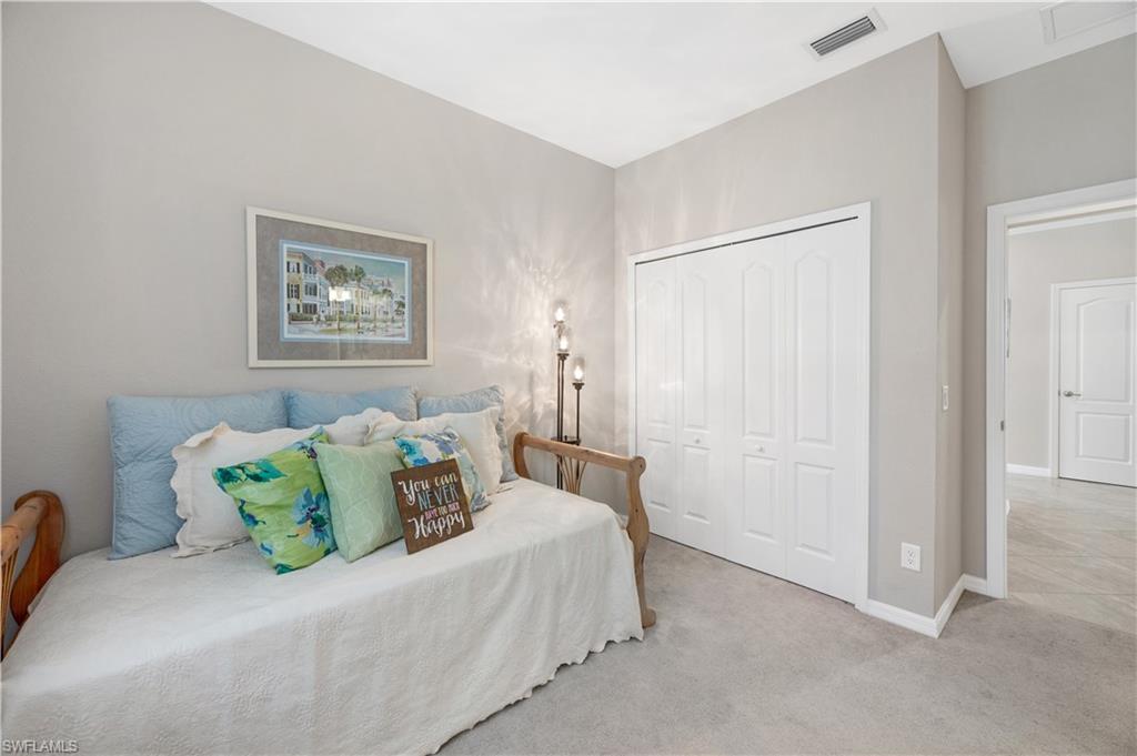 4375 Bismark Way Naples, FL 34119 - Photo 25 of 42 a bedroom with a bed and a painting on the wall
