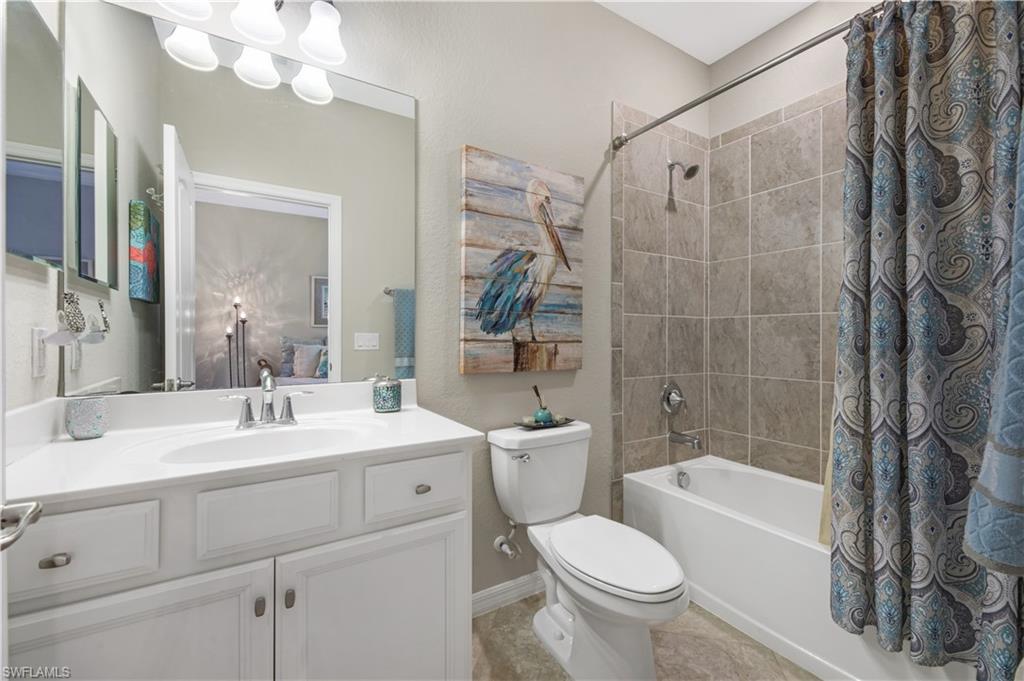 4375 Bismark Way Naples, FL 34119 - Photo 26 of 42 a bathroom with a sink a toilet and a mirror