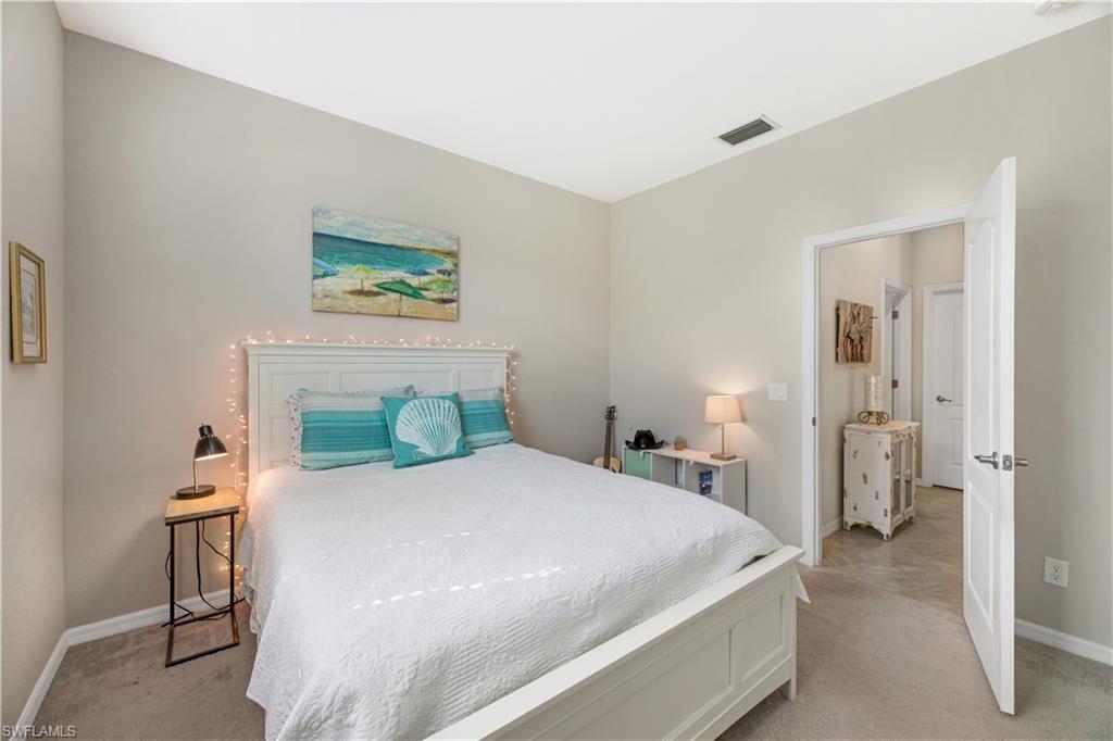 4375 Bismark Way Naples, FL 34119 - Photo 27 of 42 a bedroom with a bed and a painting on the wall