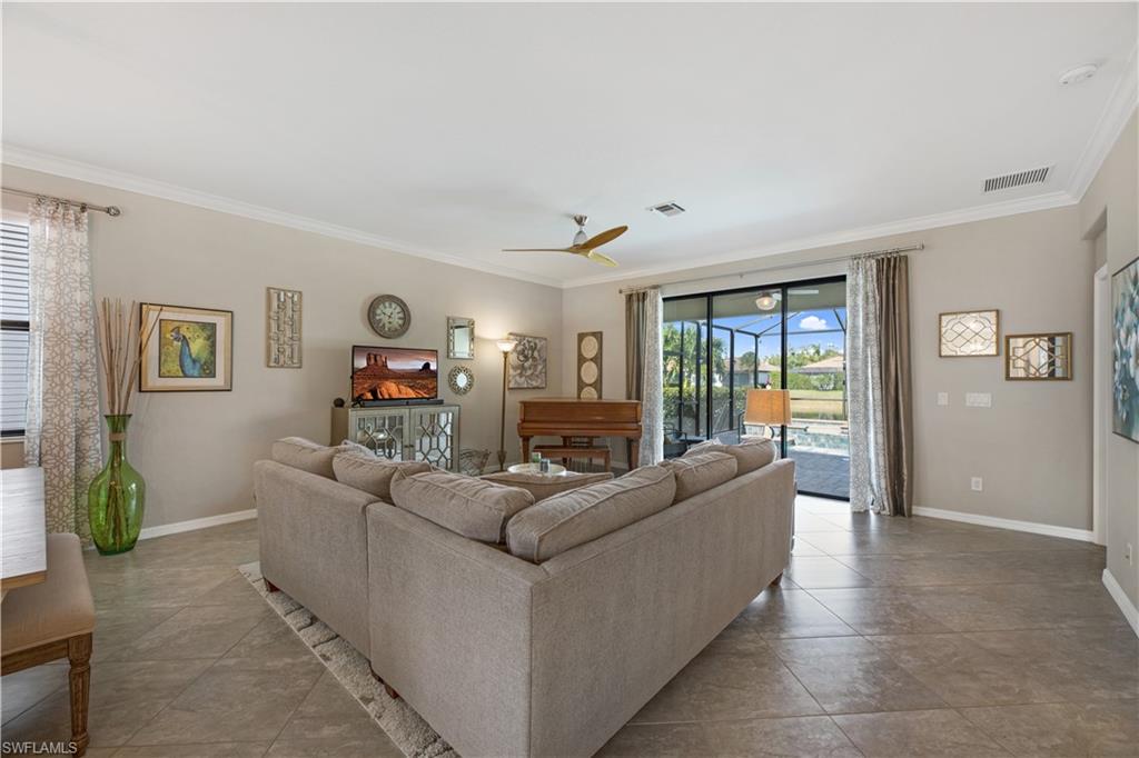 4375 Bismark Way Naples, FL 34119 - Photo 7 of 42 a living room with furniture and a flat screen tv