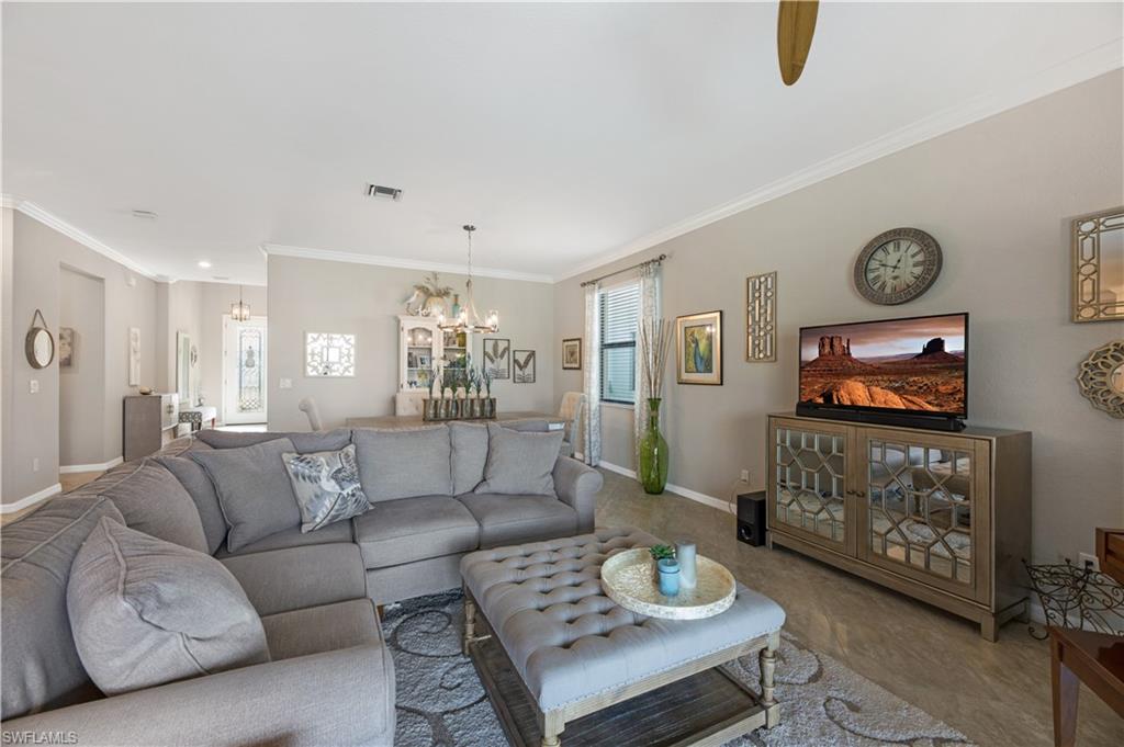 4375 Bismark Way Naples, FL 34119 - Photo 8 of 42 a living room with furniture and a flat screen tv