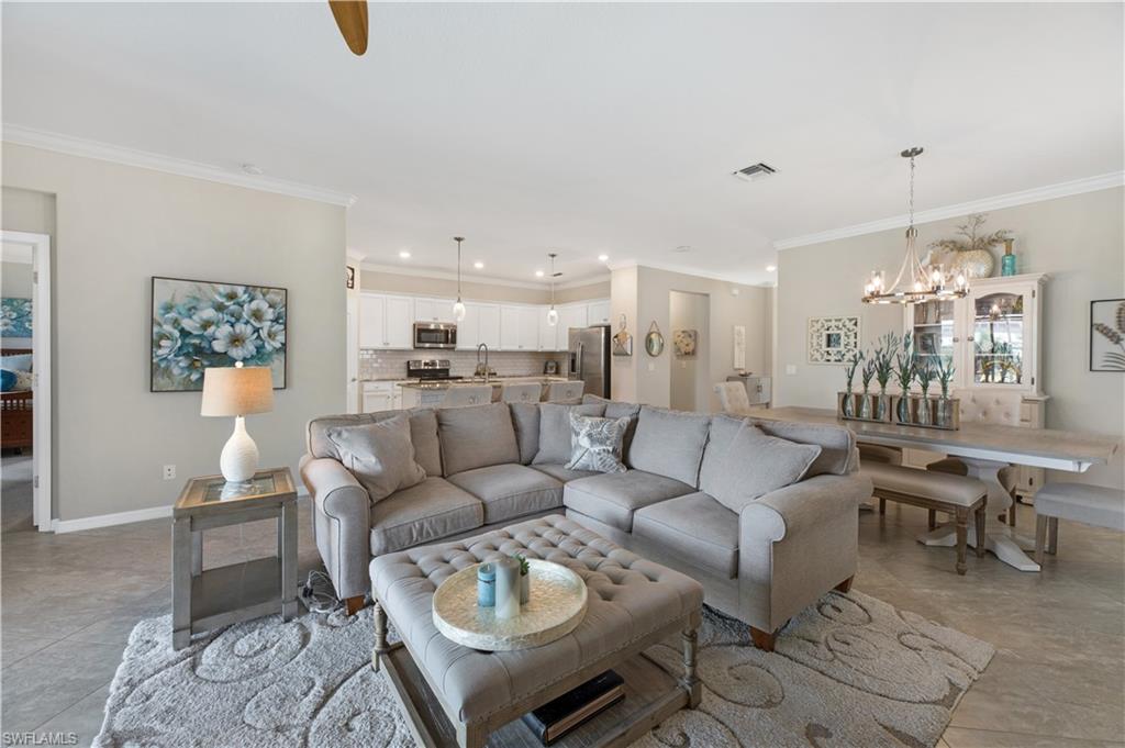 4375 Bismark Way Naples, FL 34119 - Photo 9 of 42 a living room with furniture kitchen view and a chandelier