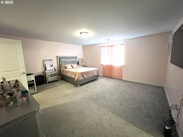 a spacious bedroom with a bed and a couch