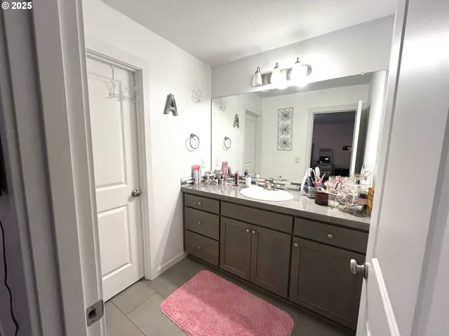 a bathroom with a sink vanity and a mirror