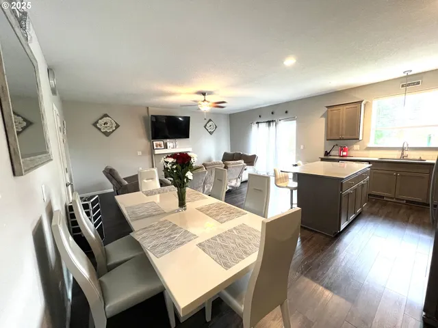 a large kitchen with a table and chairs