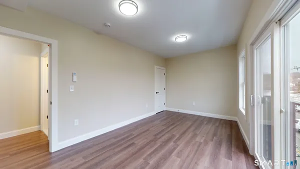 a view of a room with wooden floor