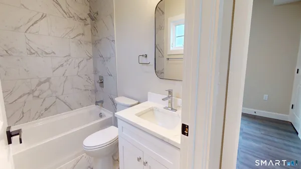 a bathroom with a sink a toilet and bathtub