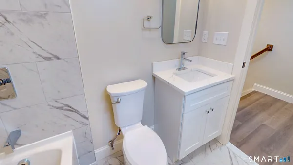 a white toilet sitting next to a bathroom sink