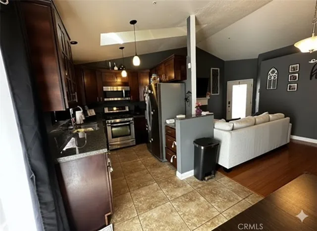 a view of a living room with furniture and a flat screen tv