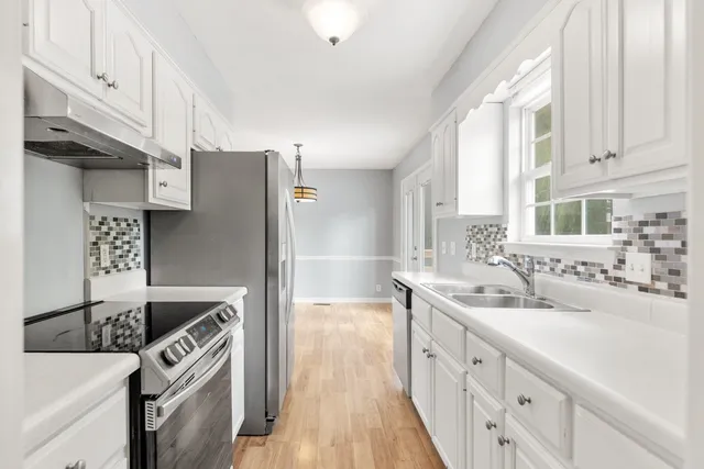 a utility room with cabinets washer and dryer