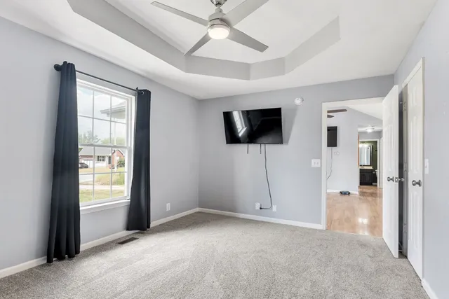 an empty room with closet and windows