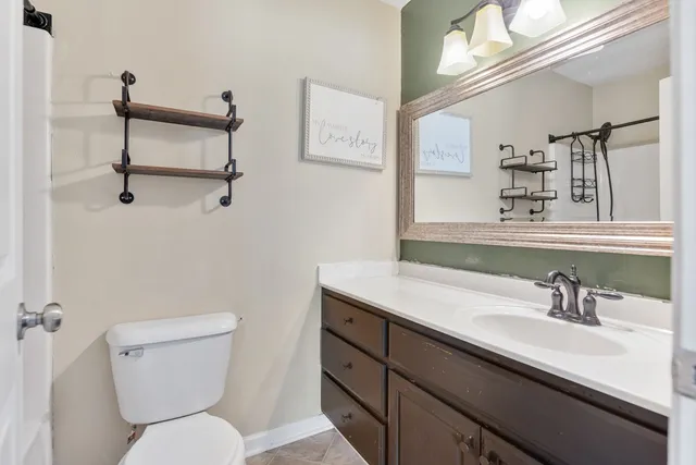 a bathroom with a sink a toilet and a mirror