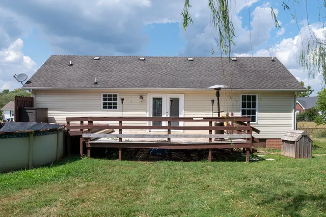 a view of a house with a backyard and a patio
