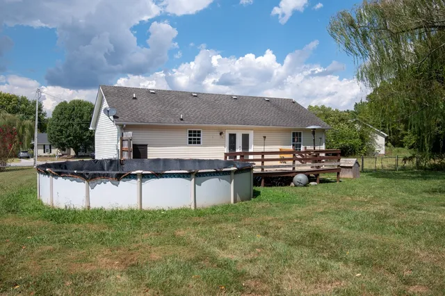 a view of balcony with wooden floor and fence