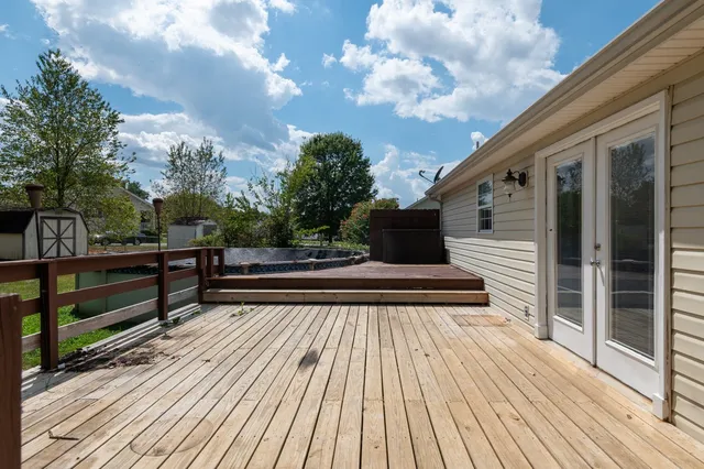 a view of a house with a yard and sitting area