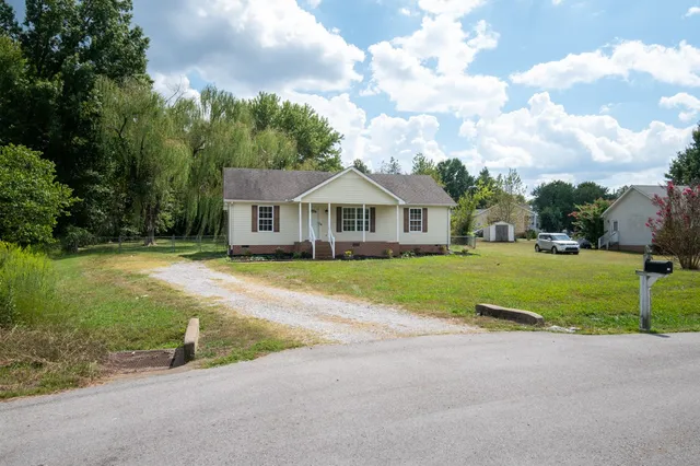 a front view of house with yard and green space
