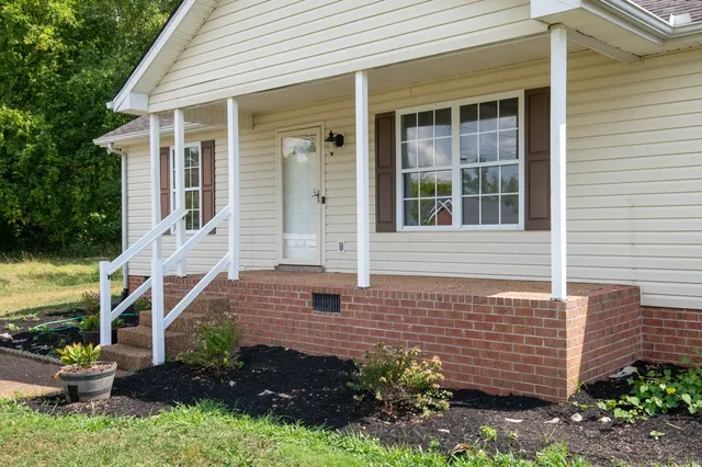 a front view of a house with a garden