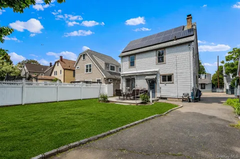 a view of a house with backyard porch and sitting area
